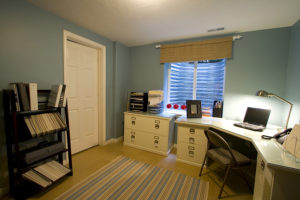A home office with a desk and storage