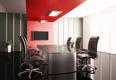 Conference room with modern office furniture and a red accent wall